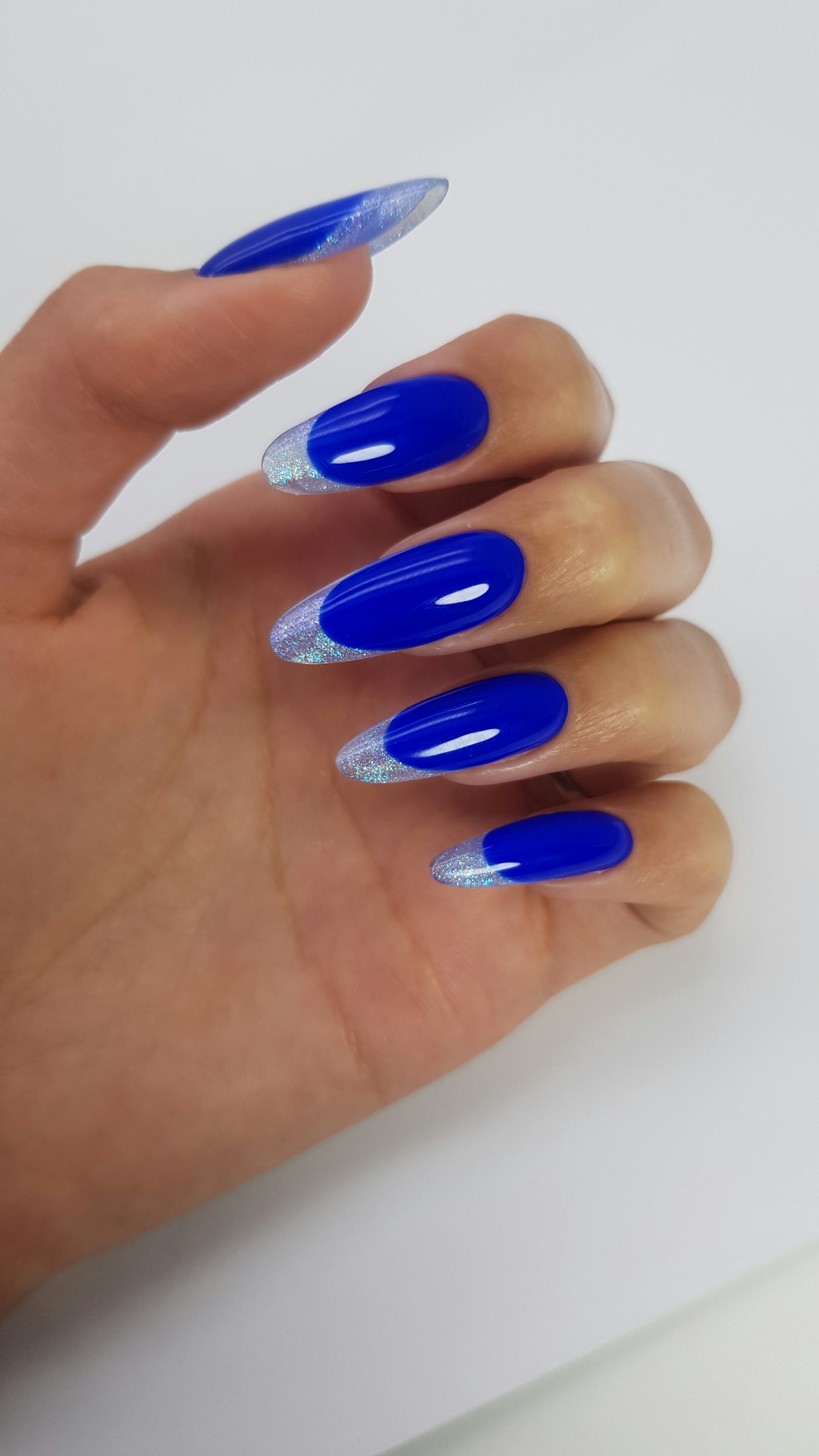 Blue almond nails with a glitter French tip