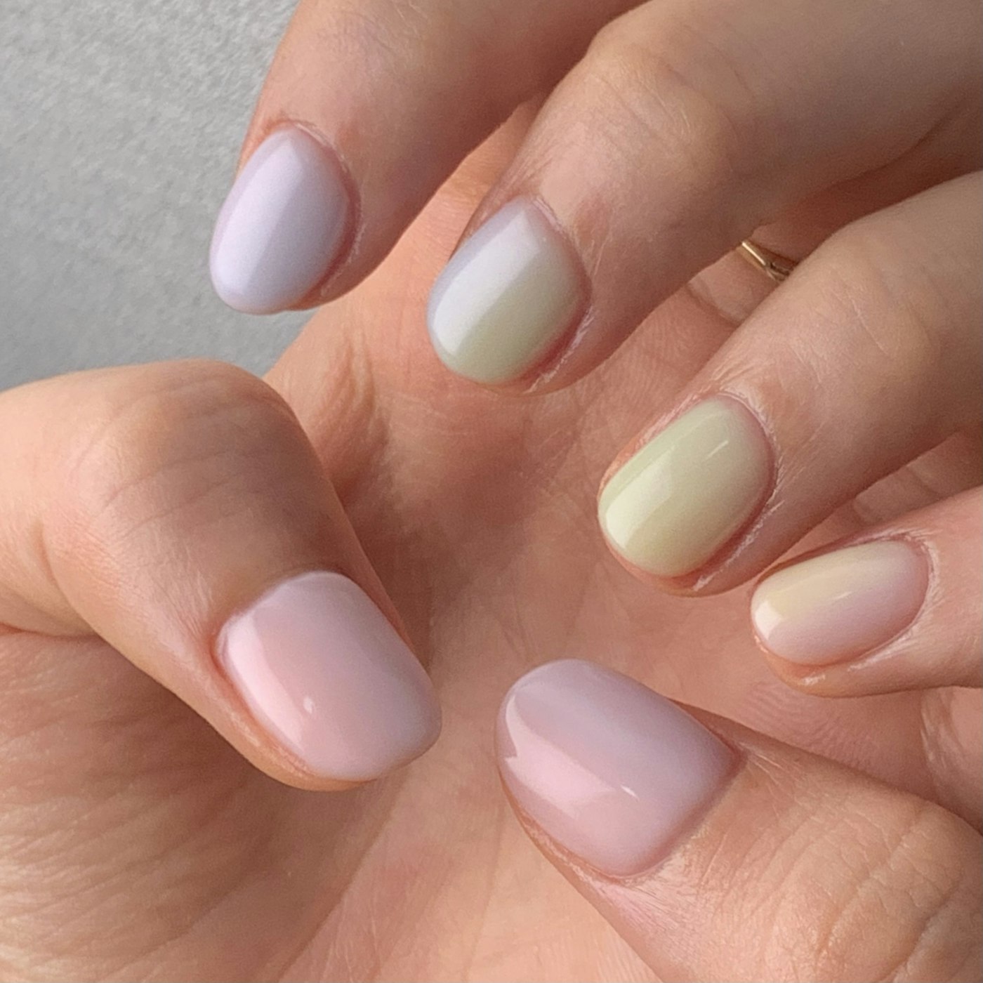 Short pastel manicure in lilac, pink, and cream