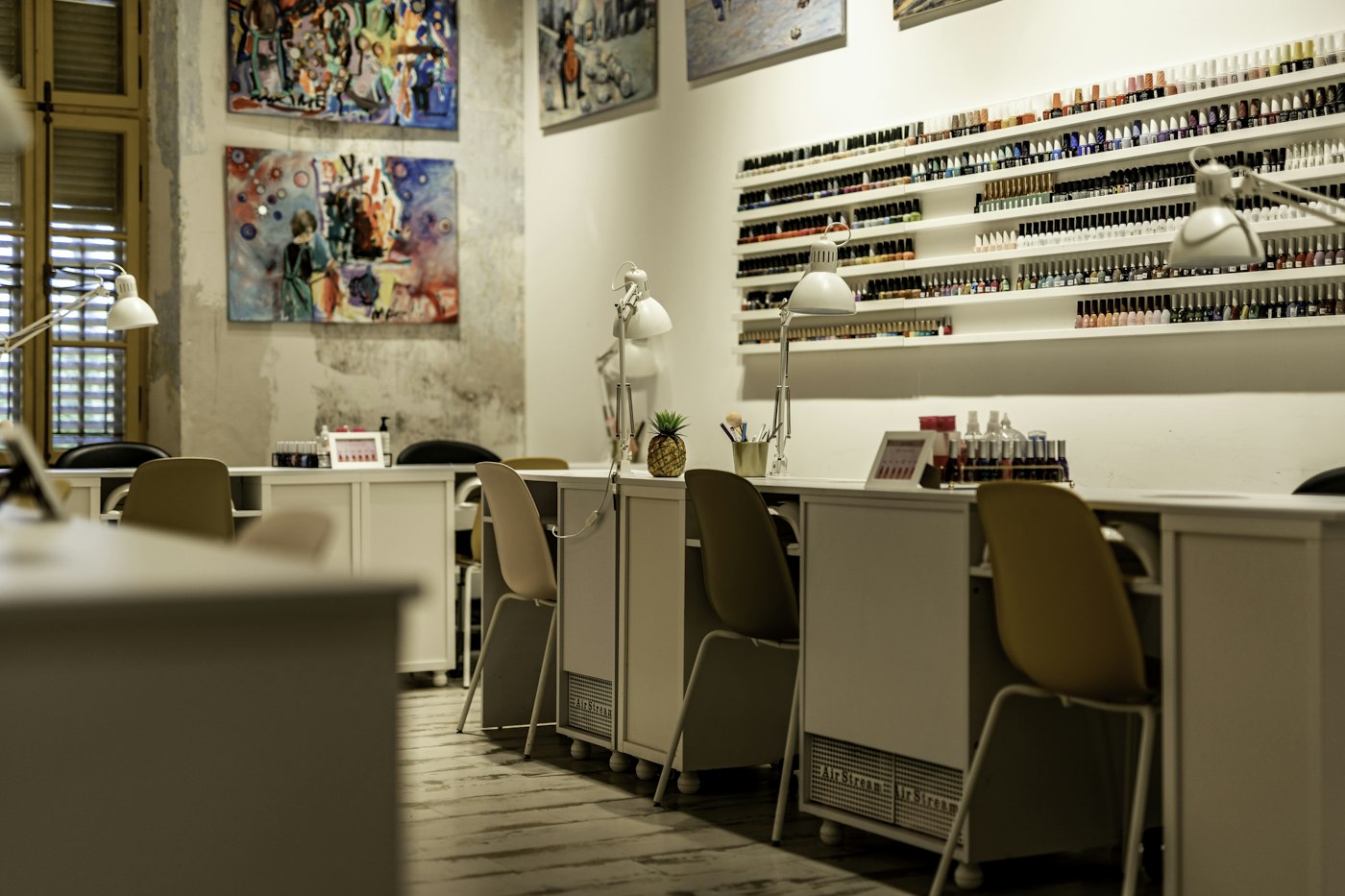 Manicure stations and a wall of nail polish