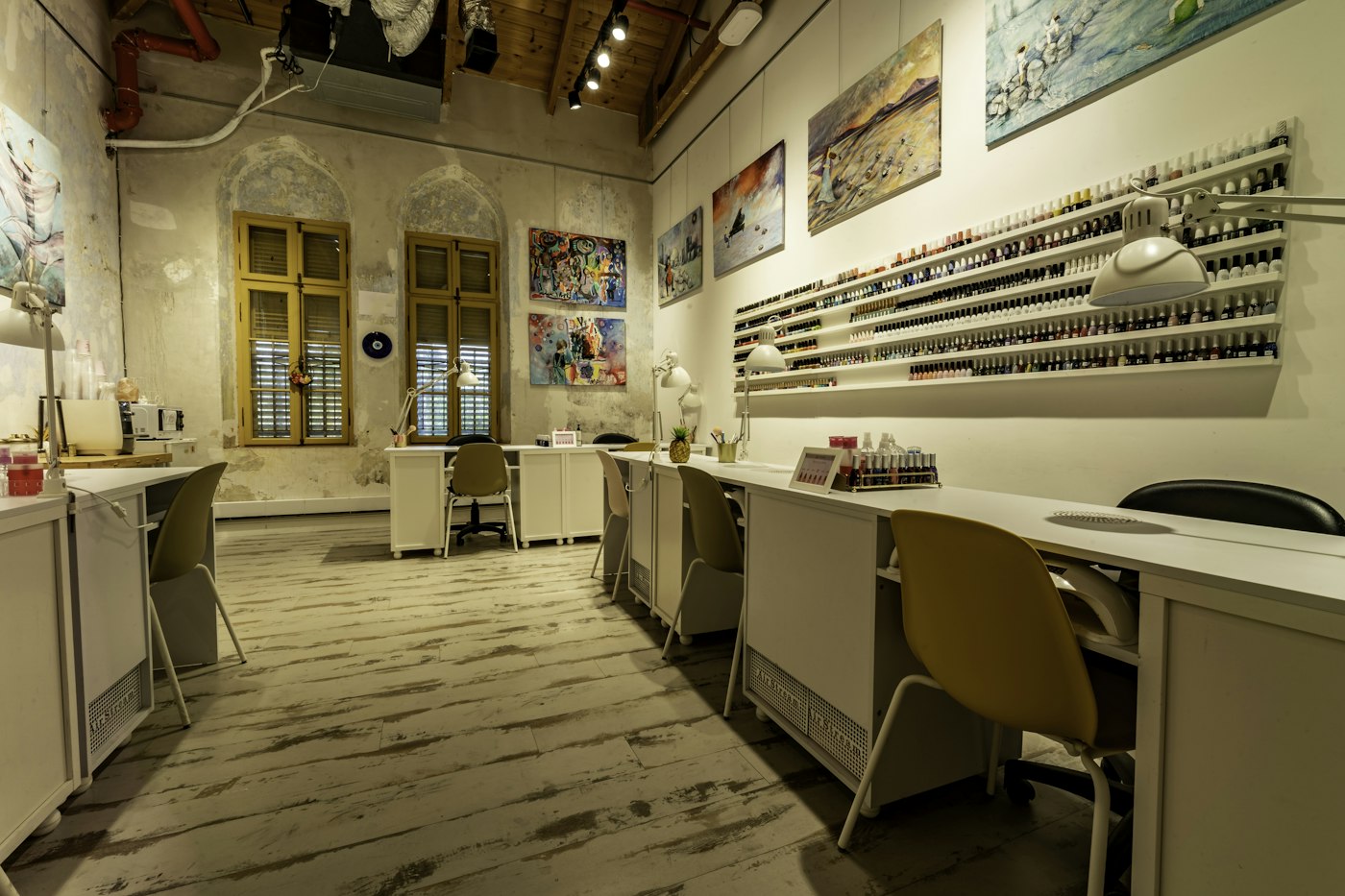 Nail salon with manicure desks and a polish wall